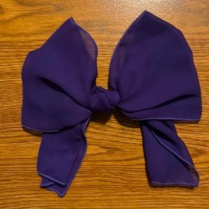 3 pc hair bows/pins. 2 purple, 1 orange.